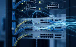 Modern network switch hardware installed in a server rack with cabling